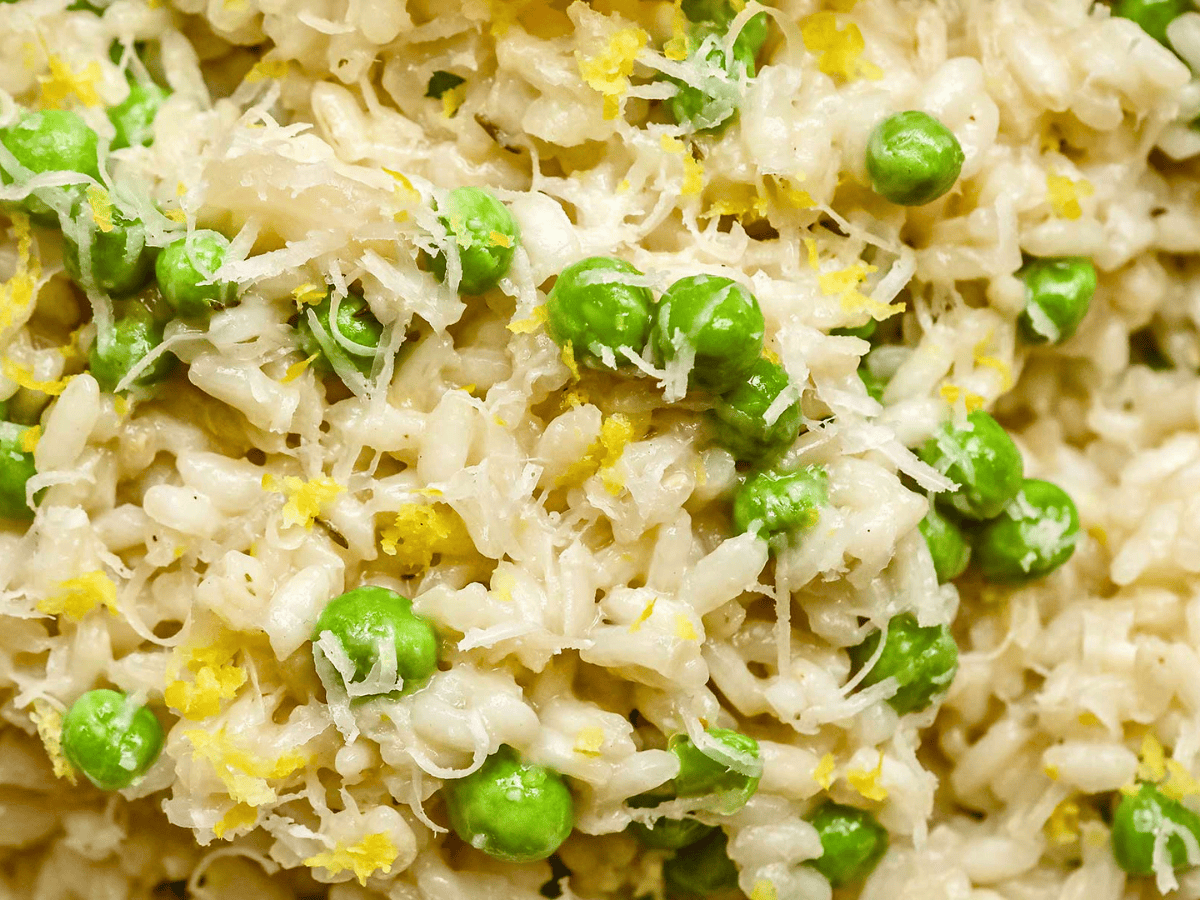 close up of rice, peas, cheese, and lemon peel