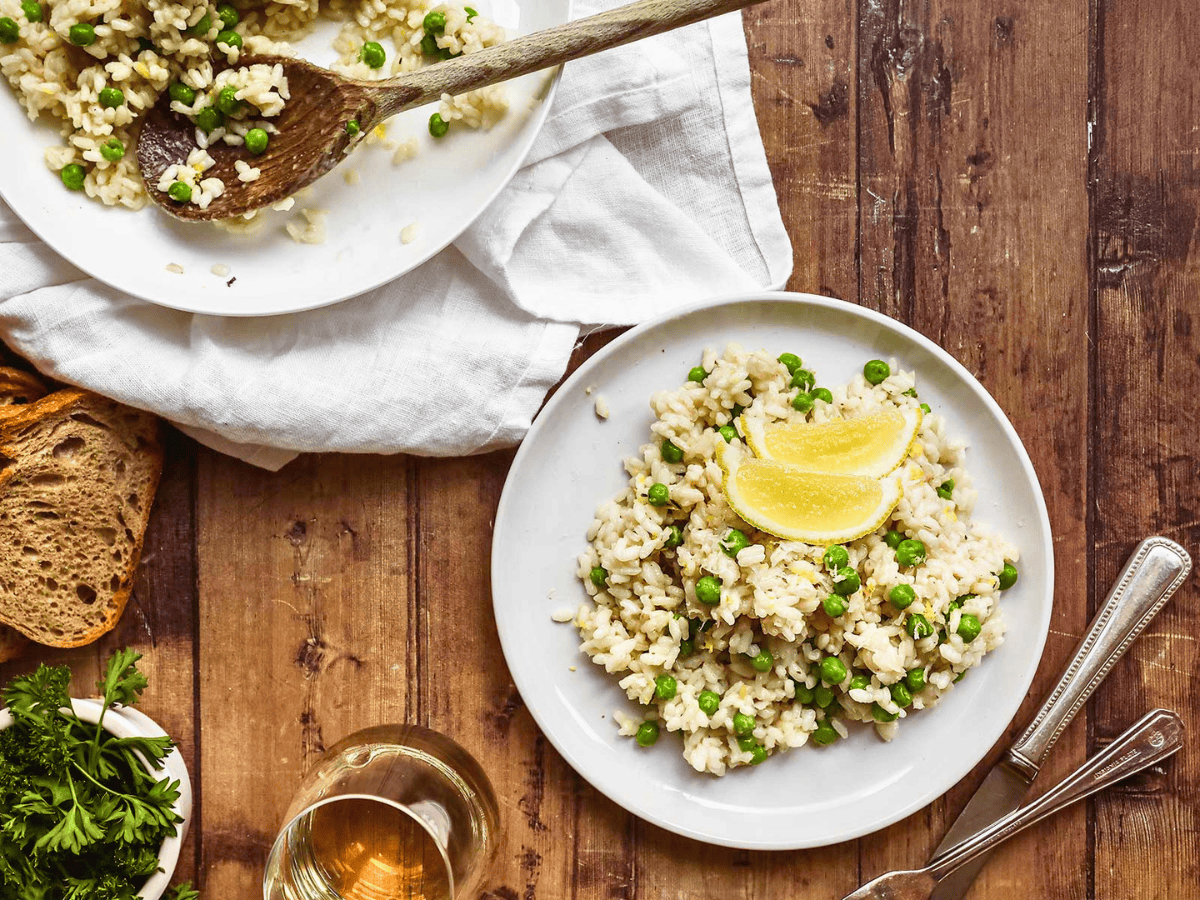 aerial view of rice, peas, and a lemon slice on a plate