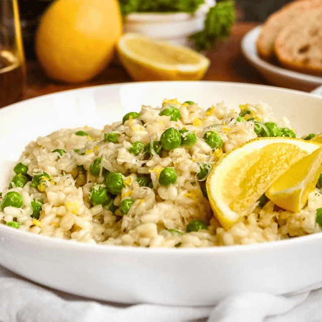 white plate of rice, peas, cheese, and lemon peel