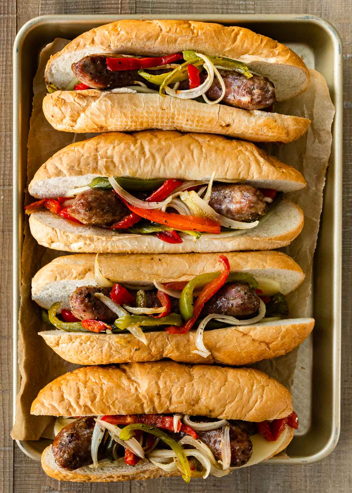 Sheet Pan Sausage and Peppers in hoagie rolls