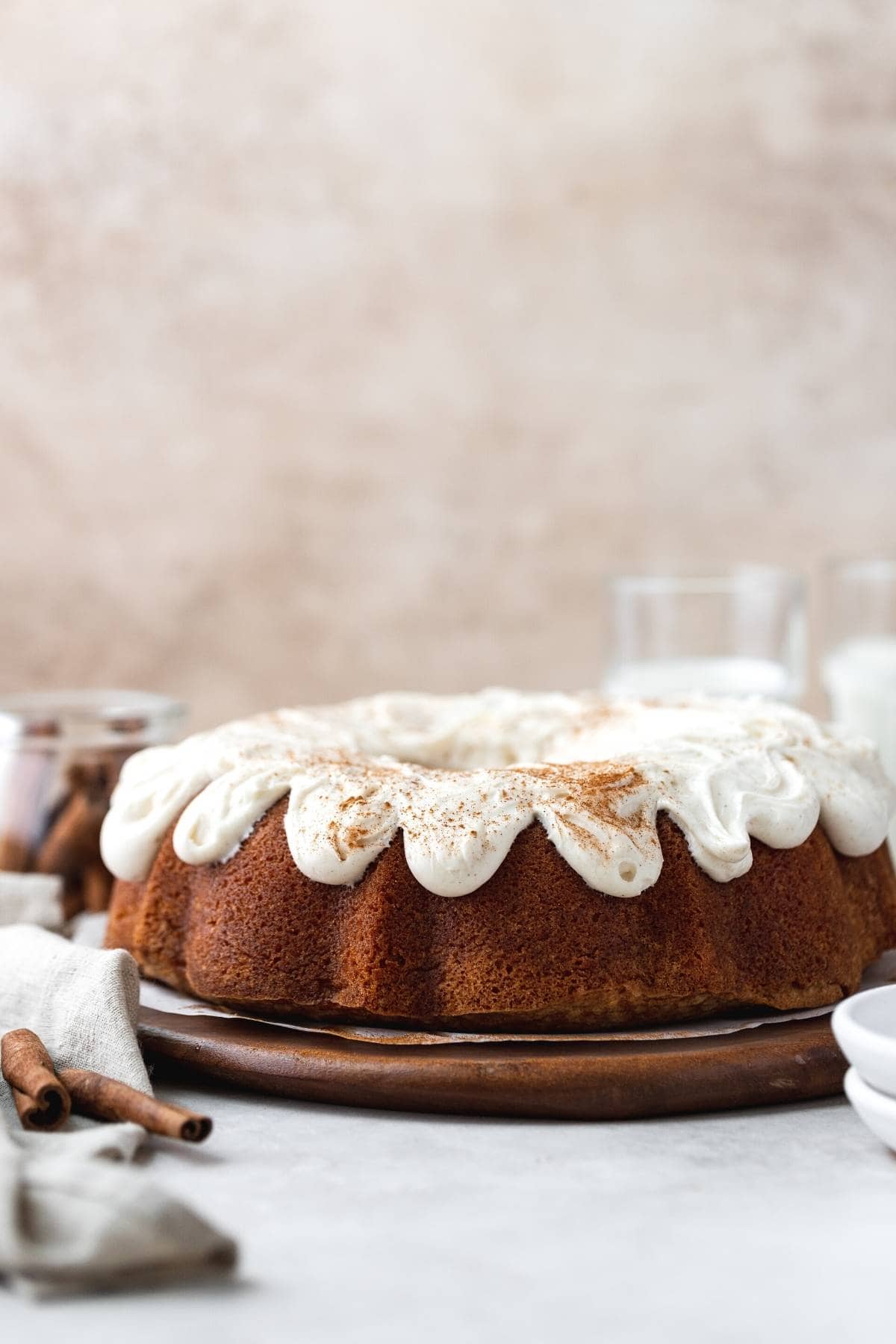 Snickerdoodle Bundt Cake with icing on serving platter