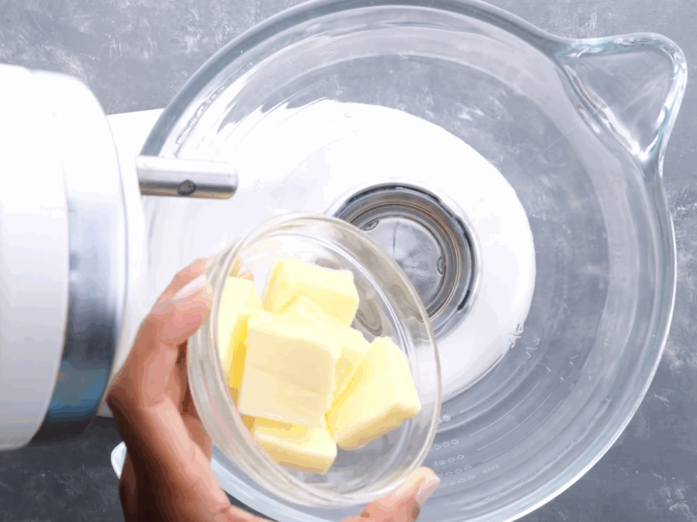 Adding butter to a mixing bowl