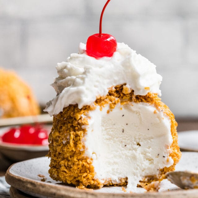 crunchy coated ice cream ball with whipped cream and cherry