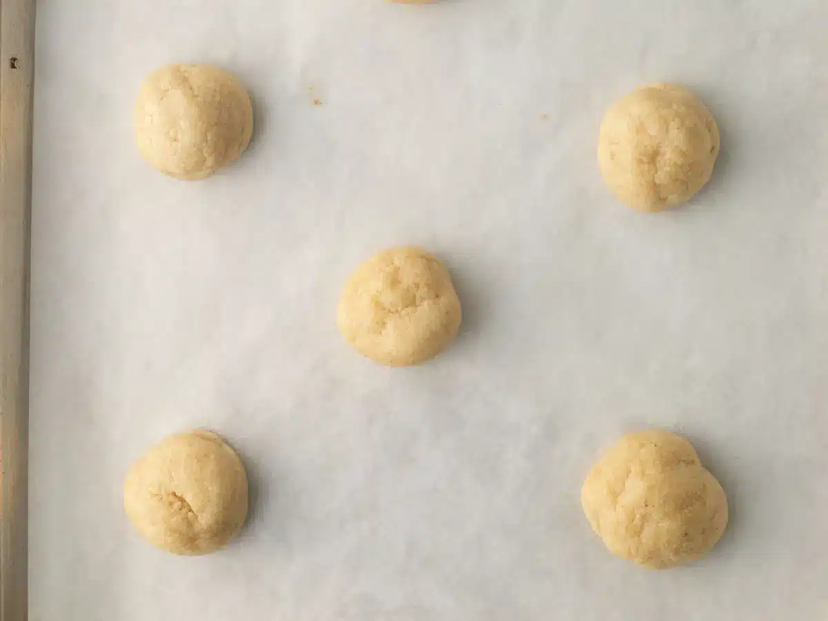 Baked cookies on parchment lined baking tray.