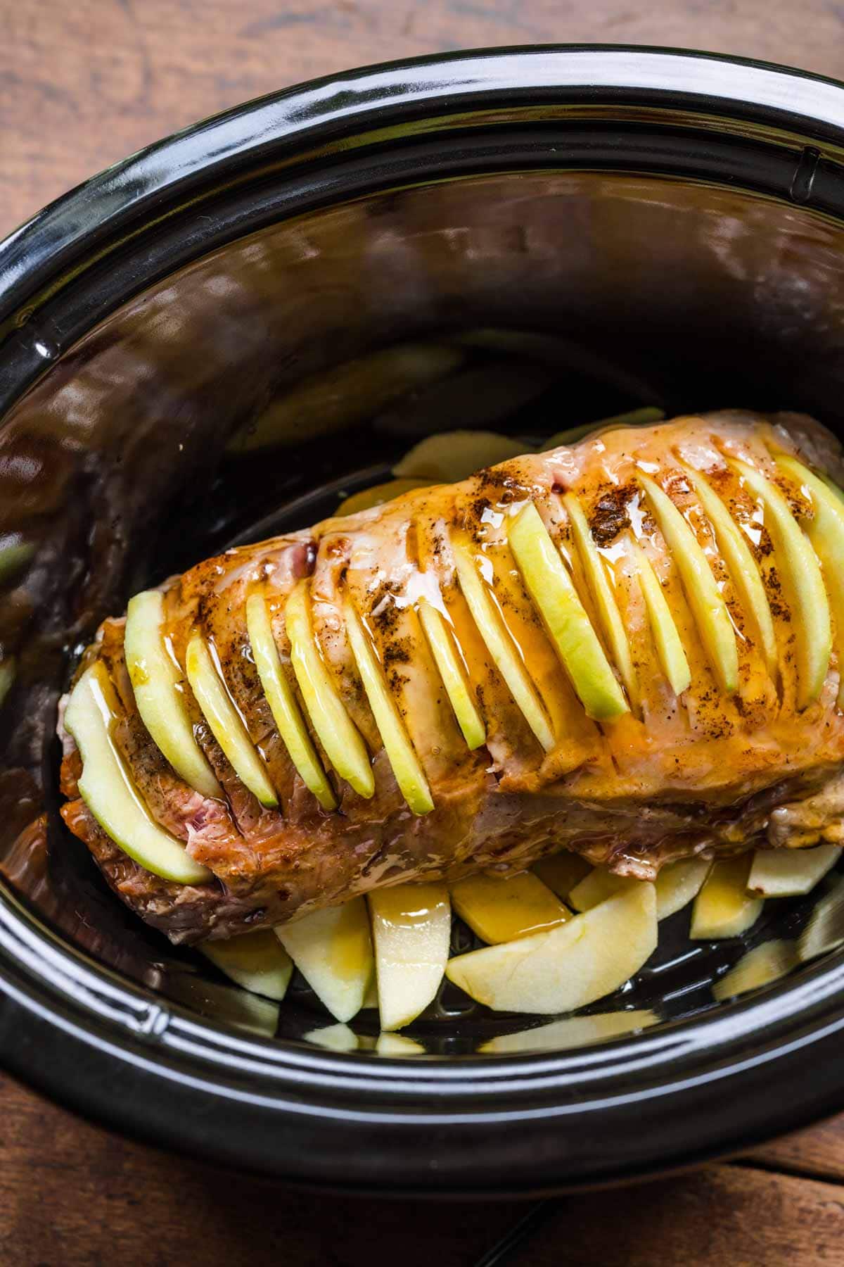 Apple Cinnamon Pork Loin in slow cooker with apple slices