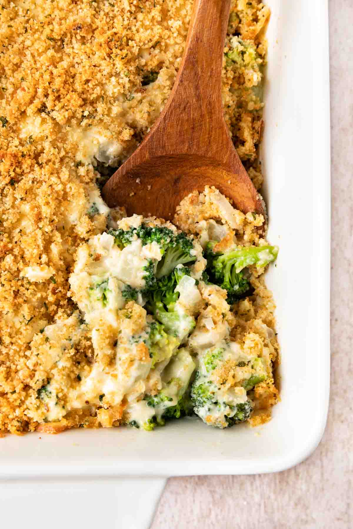 Baked Parmesan Broccoli Casserole serving spoon in casserole