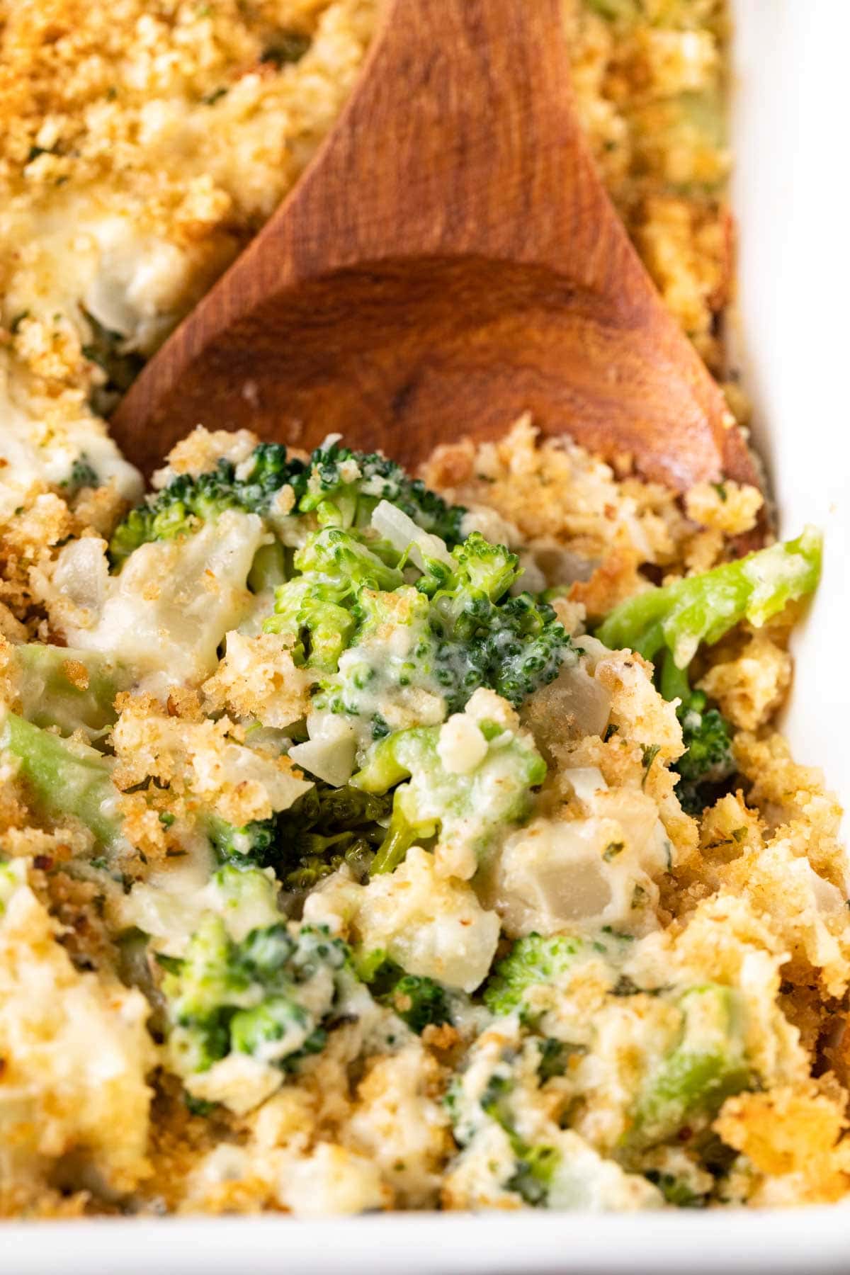 Baked Parmesan Broccoli Casserole serving spoon in casserole