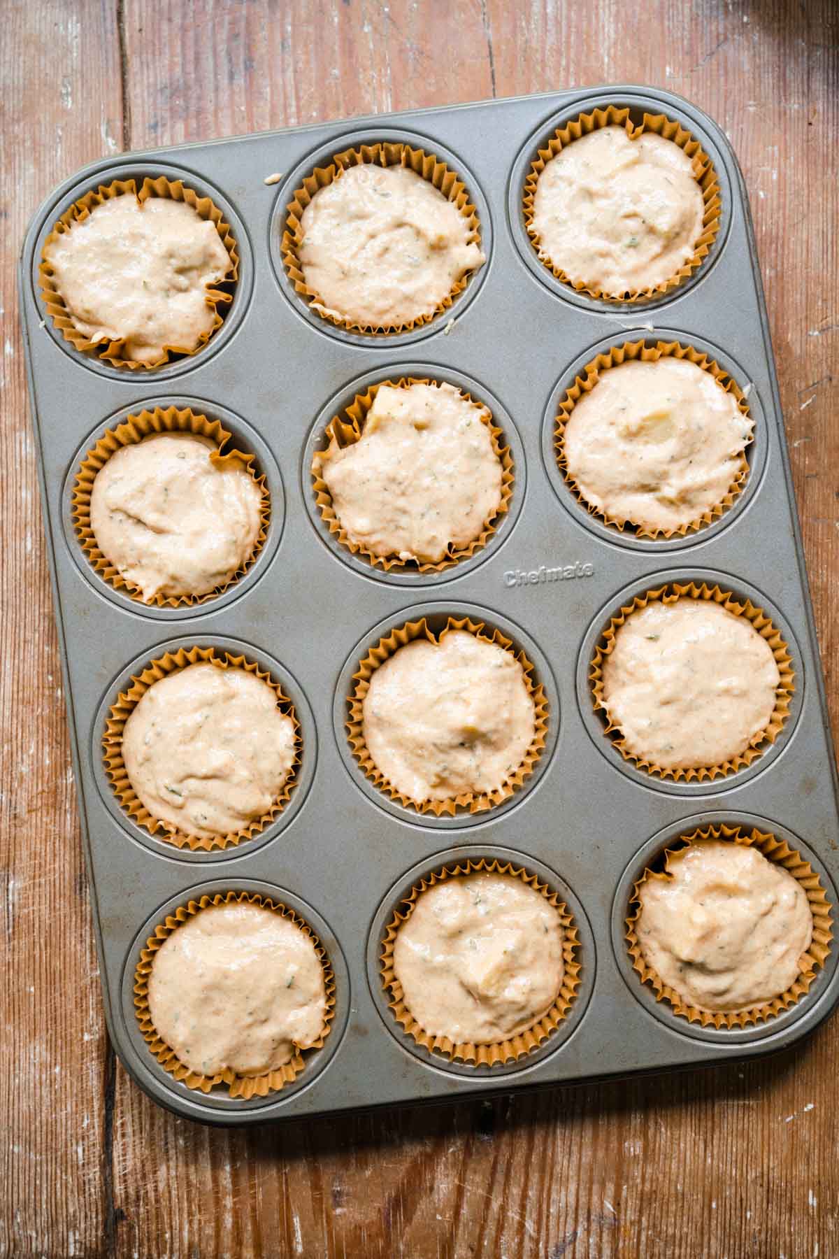 Cheesy Herb Muffins batter in muffin tin before bakin