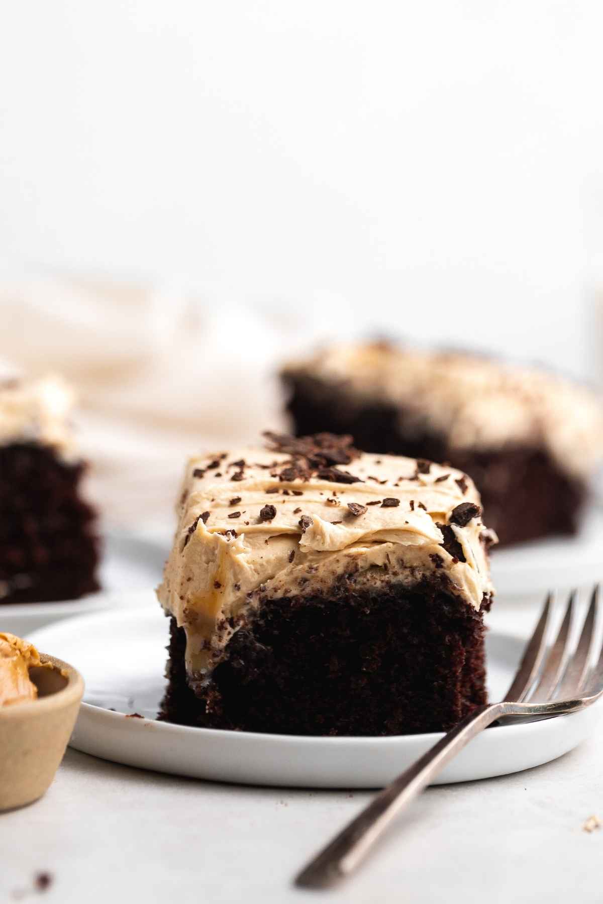 Peanut Butter Chocolate Poke Cake slice on plate with fork