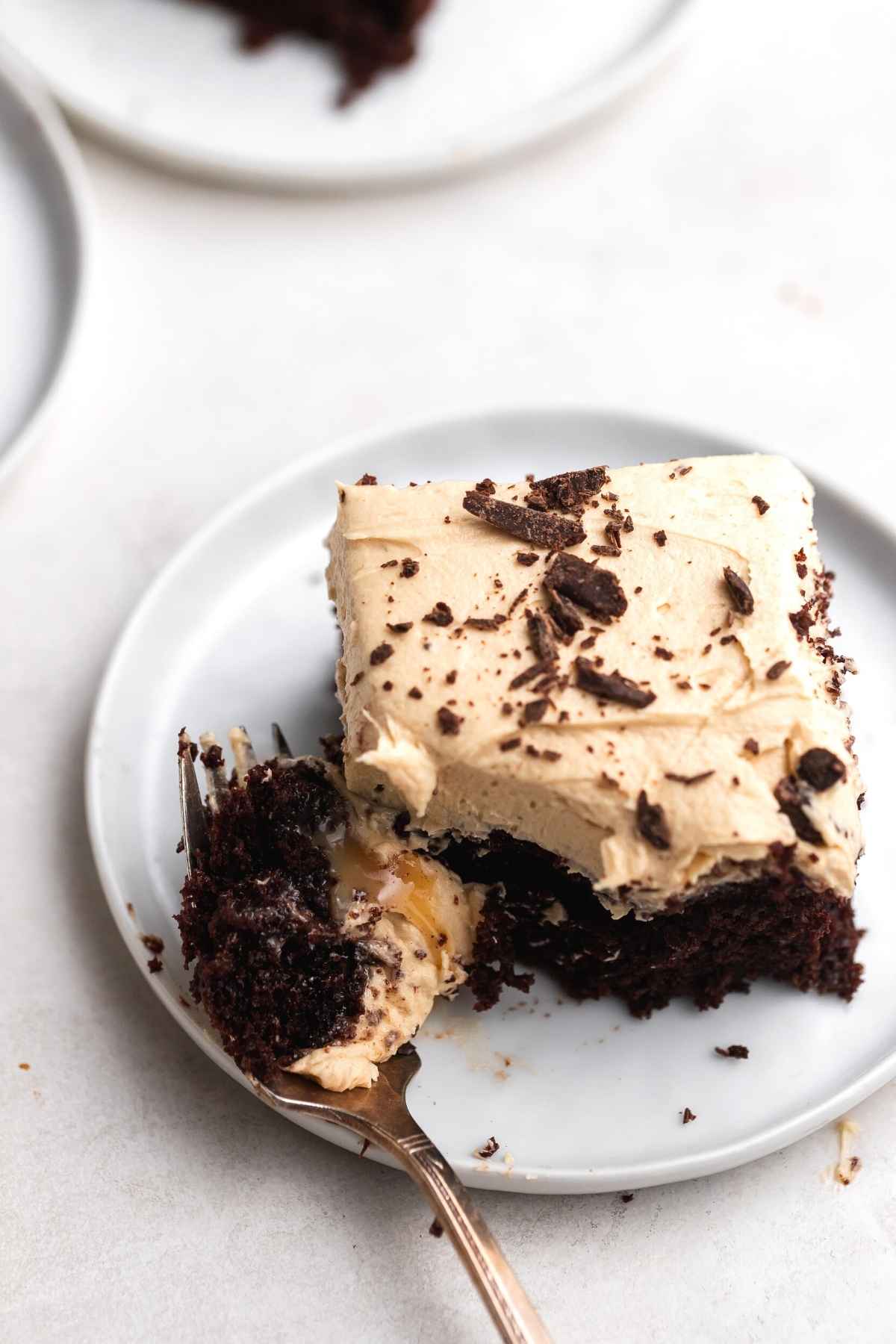 Peanut Butter Chocolate Poke Cake slice on plate with fork