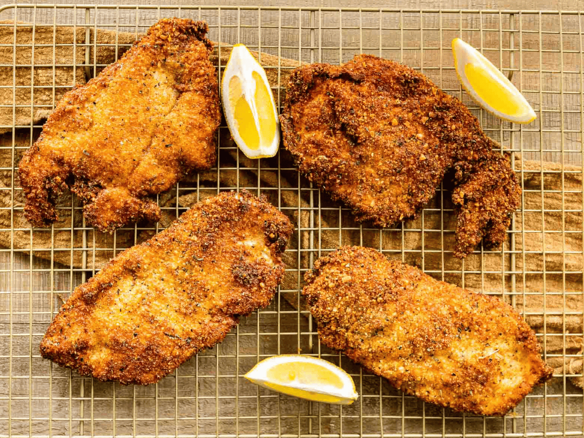 Chicken on cooling rack with lemons