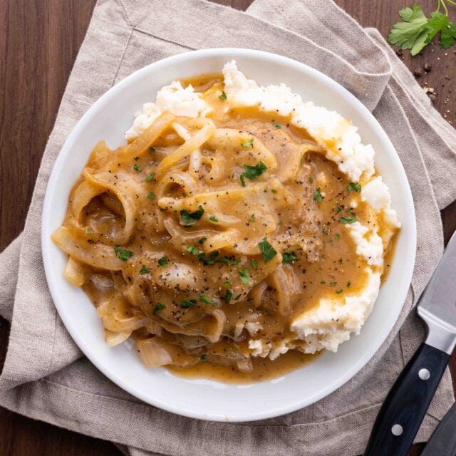 Cube steak with gravy on plate with mashed potatoes header image