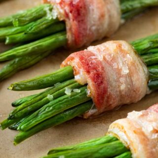 Green Bean Bundles wrapped in bacon cooked on baking sheet