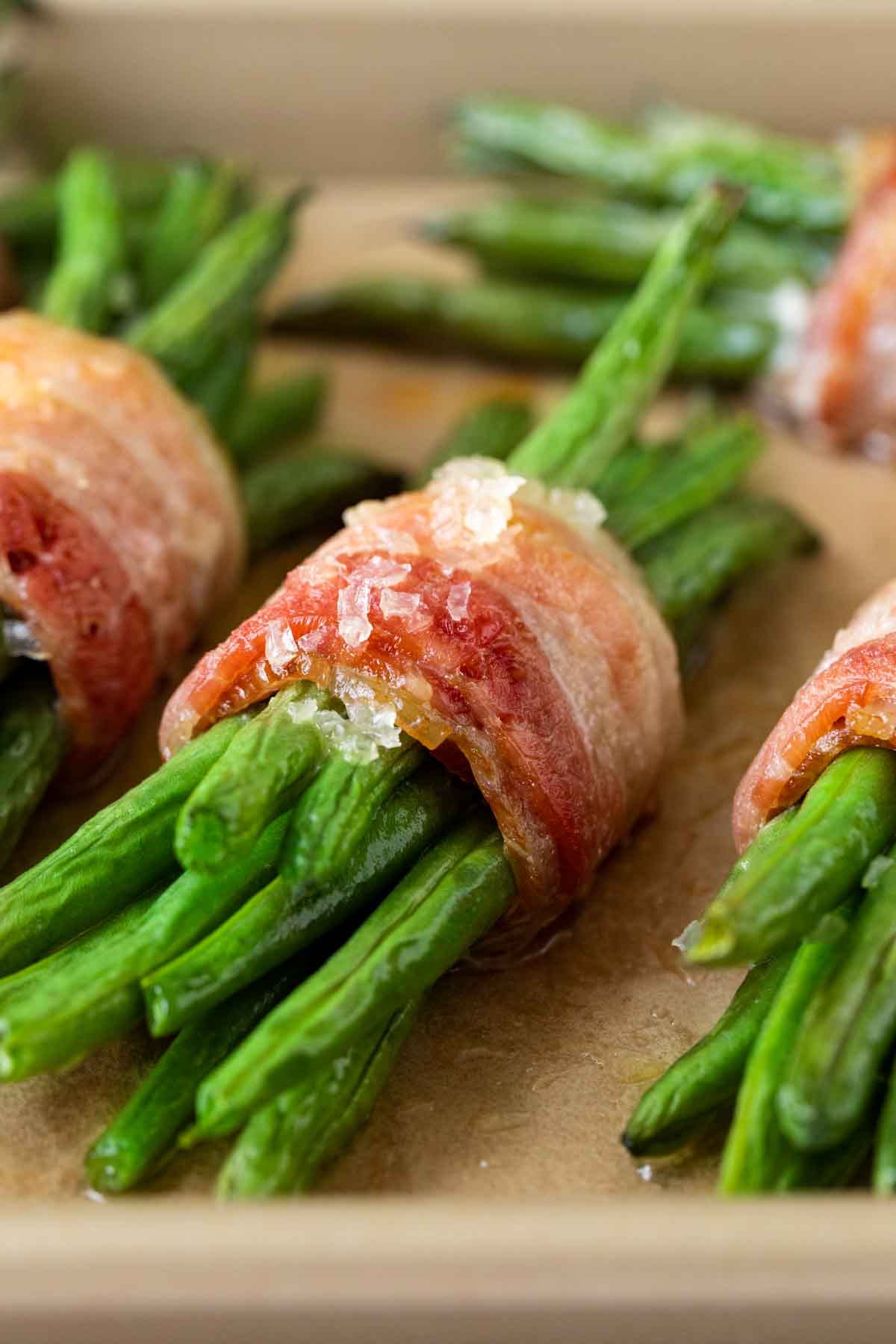 Green Bean Bundles wrapped in bacon cooked on baking sheet