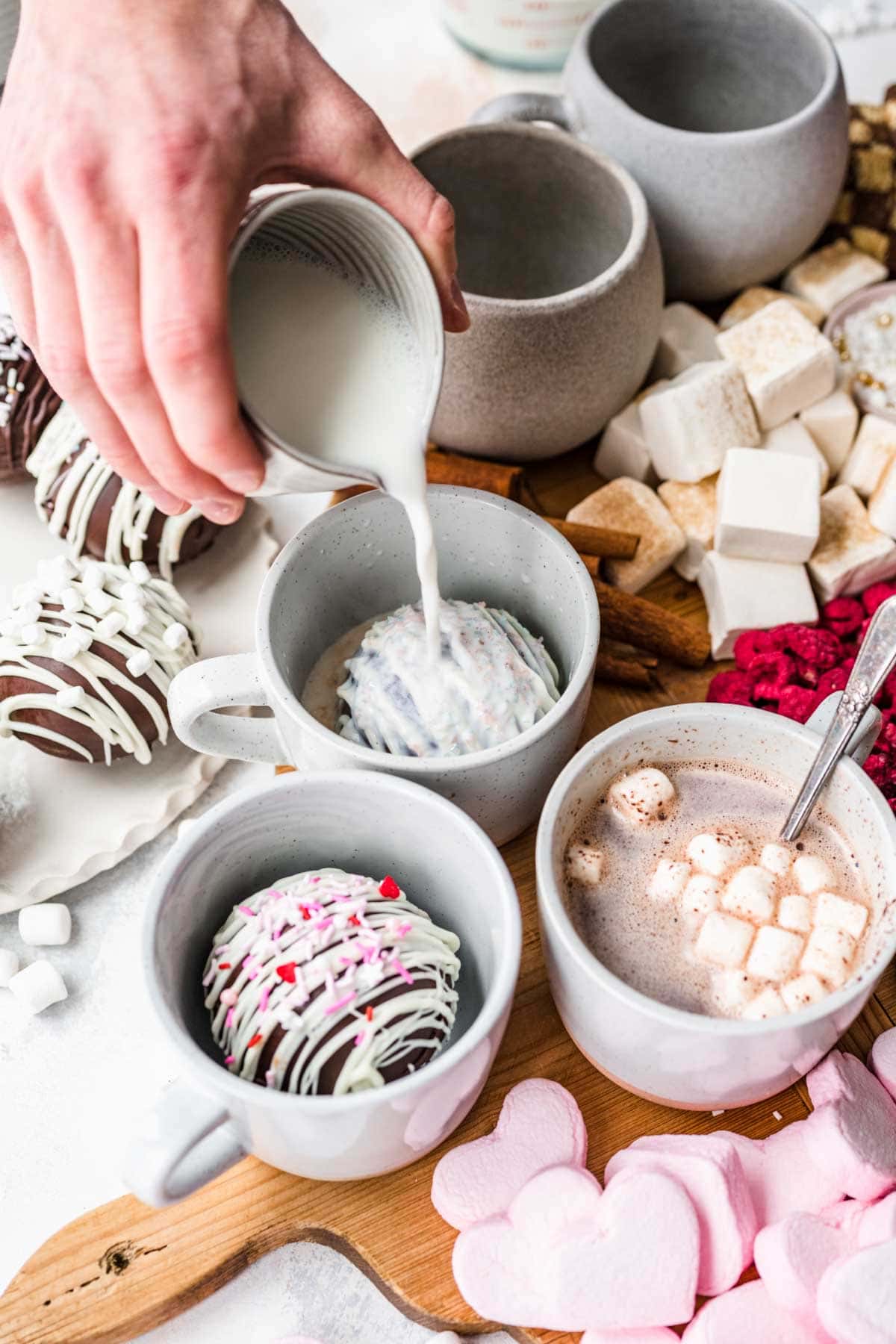 Hot Chocolate Bombs in mug with milk pouring