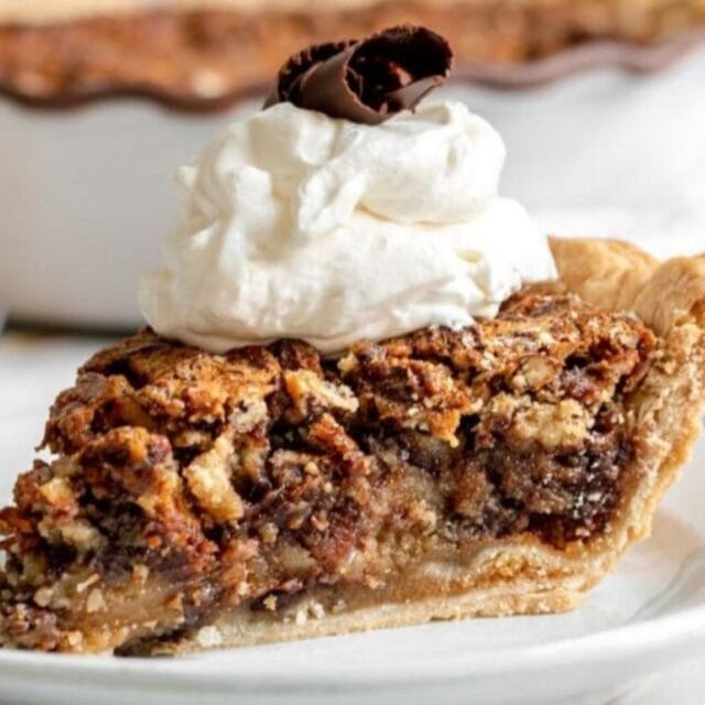 A slice of pie with whip cream on top