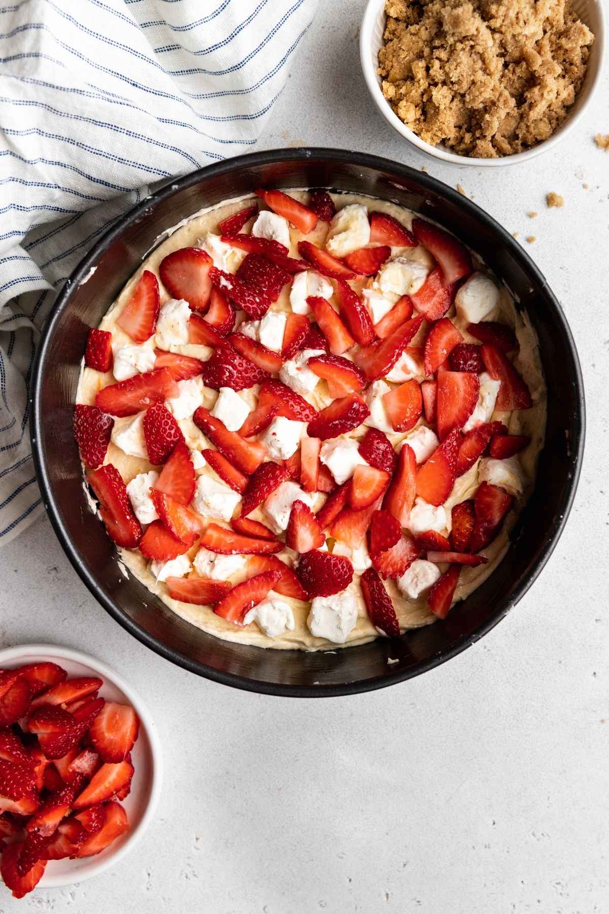 Strawberry Cream Cheese Coffee Cake batter in pan with strawberries on top