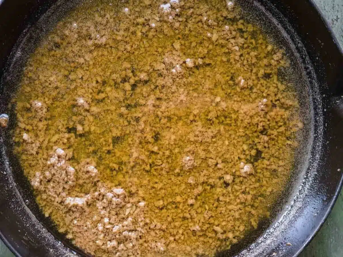Warm buttery dipping sauce cooked in pan.