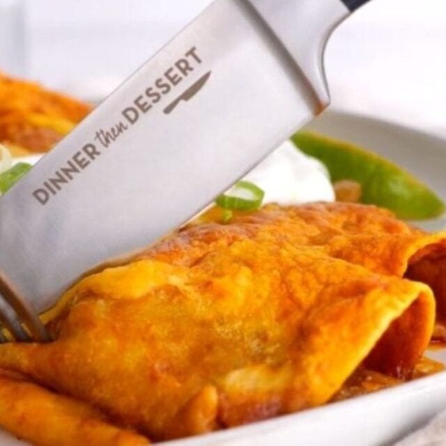 An enchilada on a white plate with a knife cutting the enchilada.