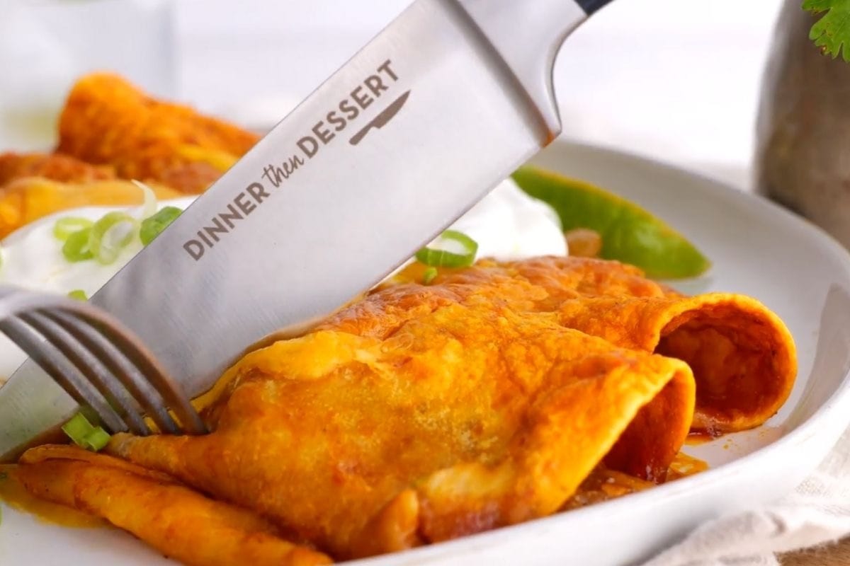 close up Beef enchiladas on plate topped with sour cream and dinner then dessert branded chef's knife