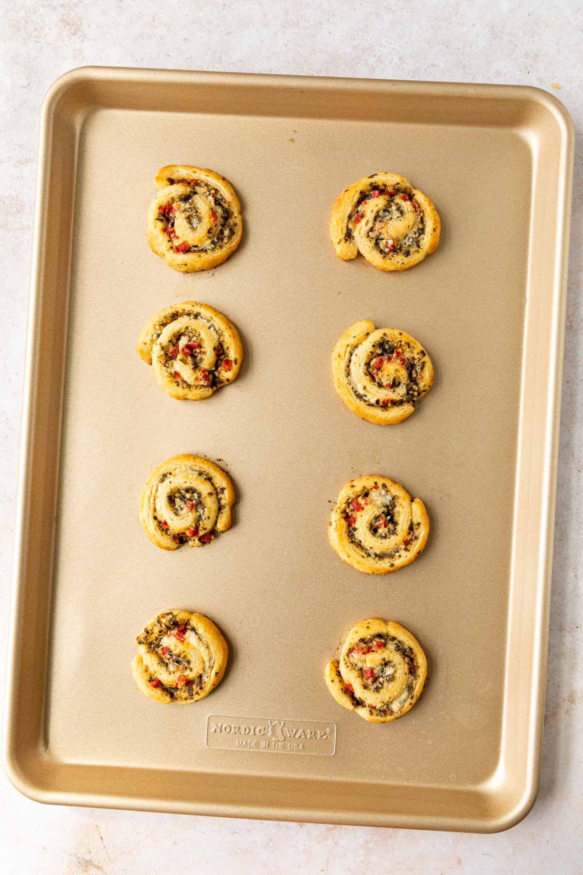 Cheesy Pesto Pinwheels on baking sheet