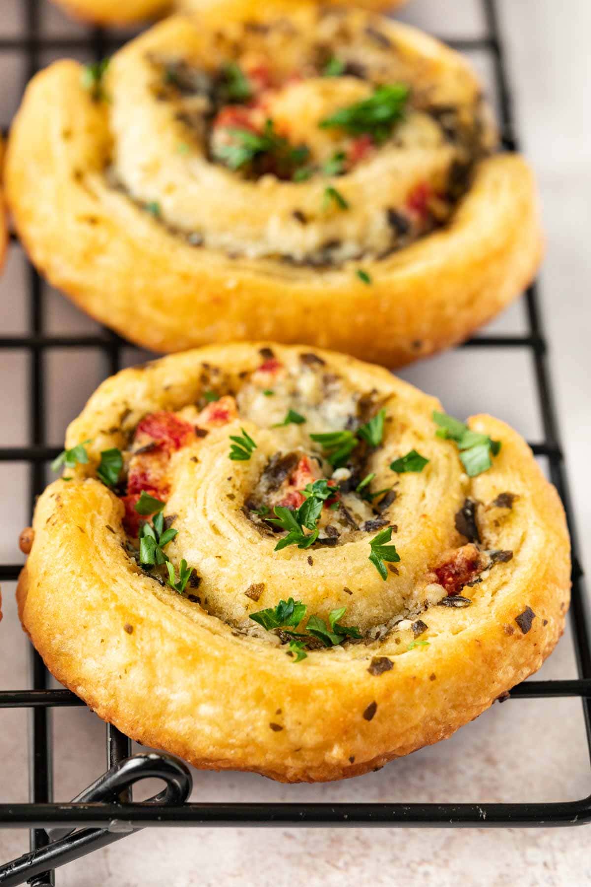 Cheesy Pesto Pinwheels on cooling rack