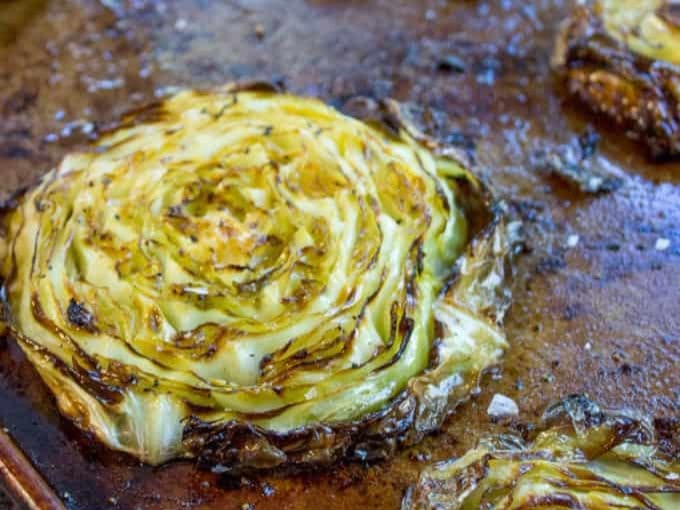 Cabbage steak roasted on baking sheet.