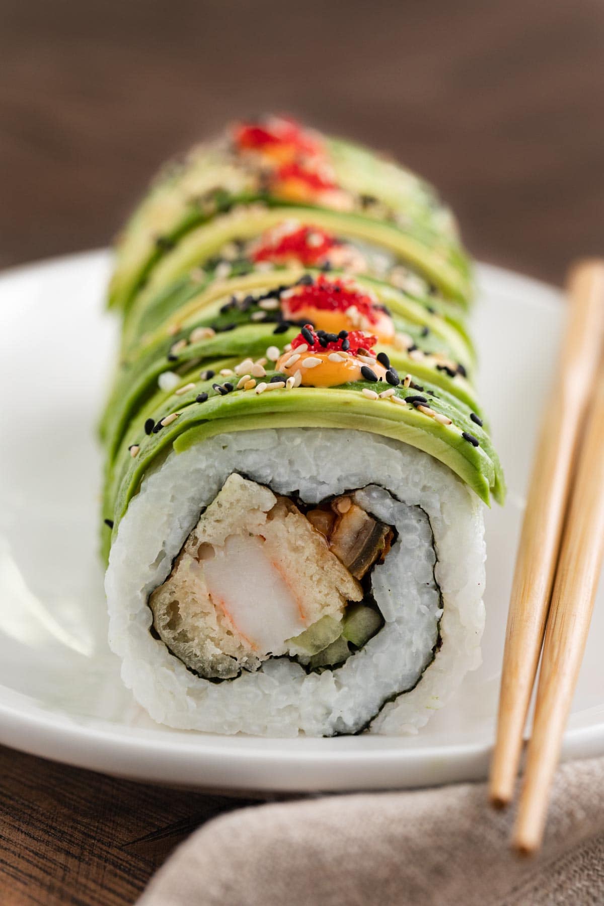 Dragon Roll on serving plate with chopsticks