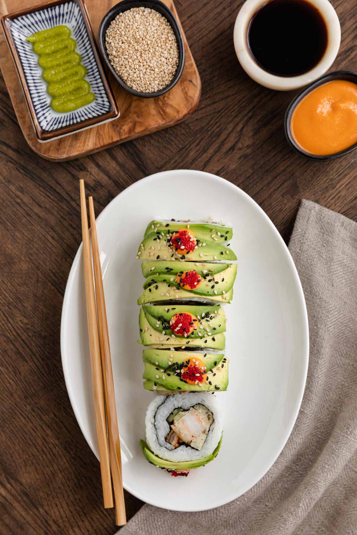 Dragon Roll on serving plate with chopsticks