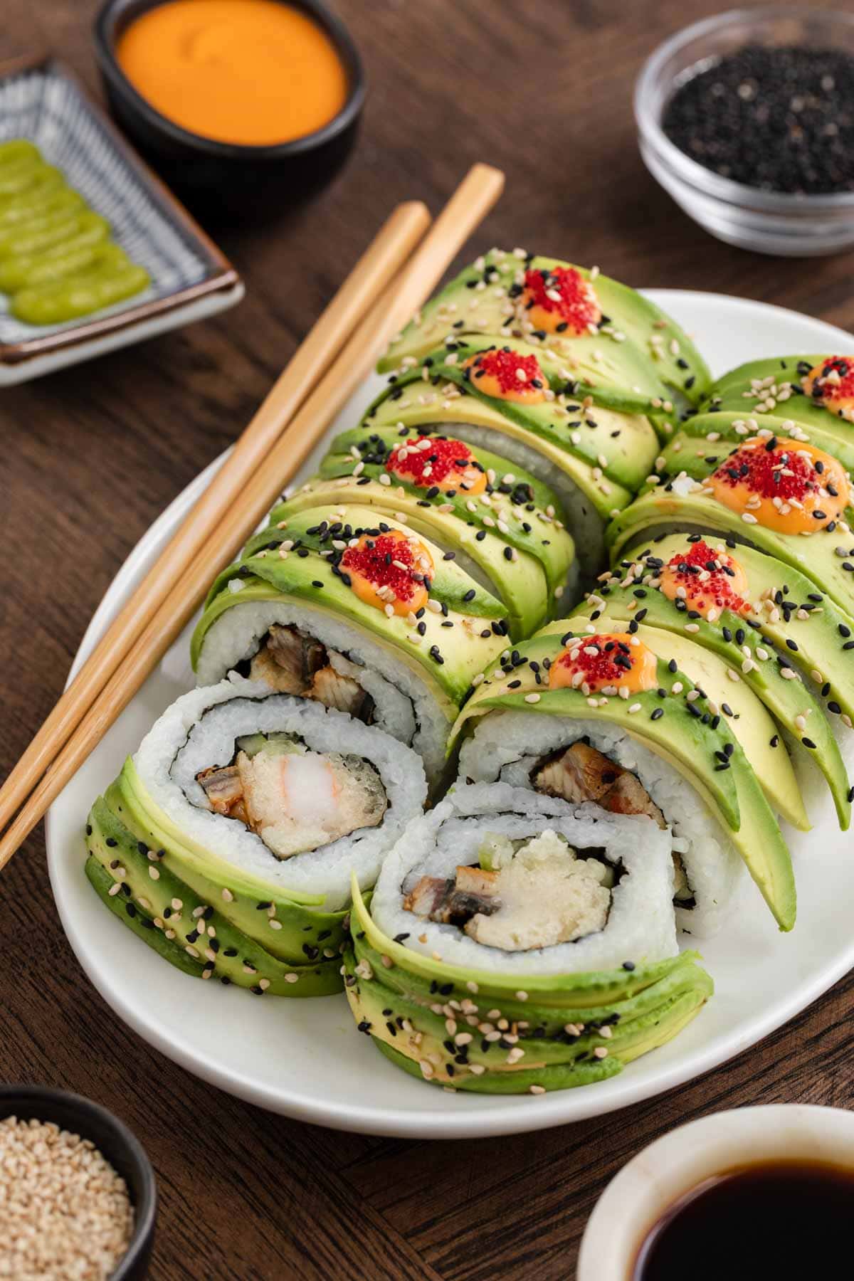 Dragon Roll pair on serving plate with chopsticks