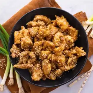 Chicken served in bowl with chop sticks