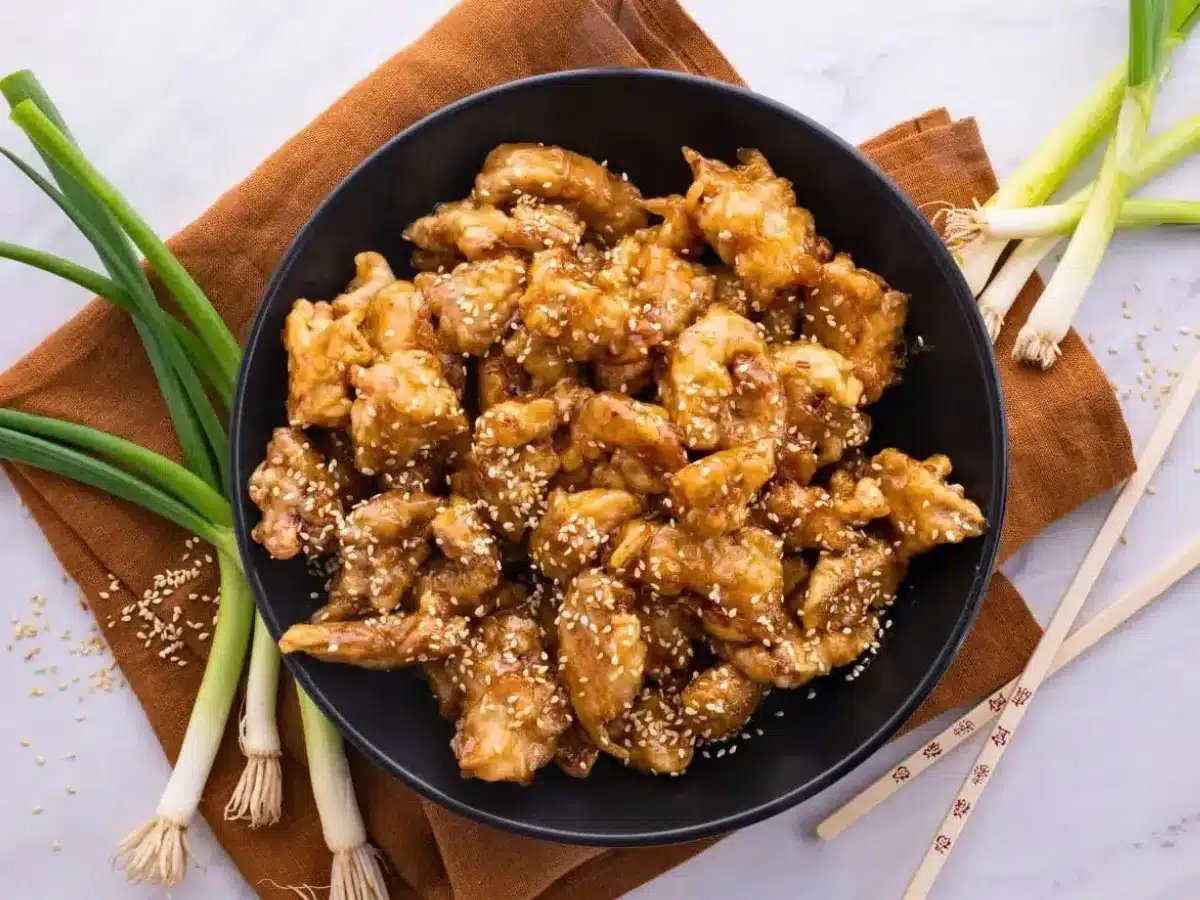 Chicken served in bowl with chop sticks