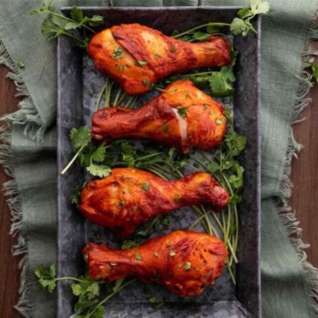 Drumsticks on a platter with garnish