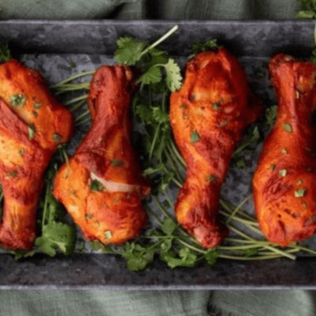 chicken on a platter with cilantro underneath