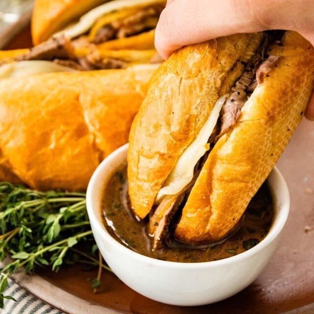 French Dip Sandwiches dipping in au jus 1x1