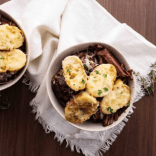 two bowls of french onion roast on top of white towel
