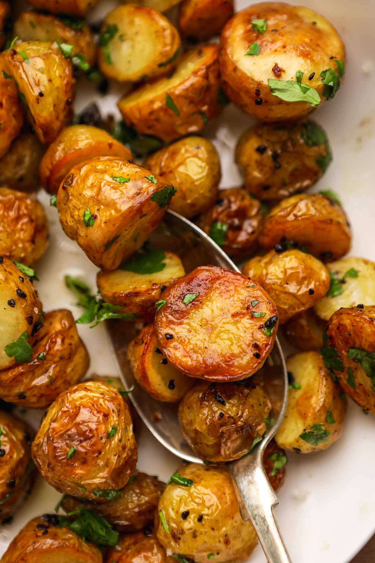 Garlic Butter Roasted Potatoes in spoon on serving plate