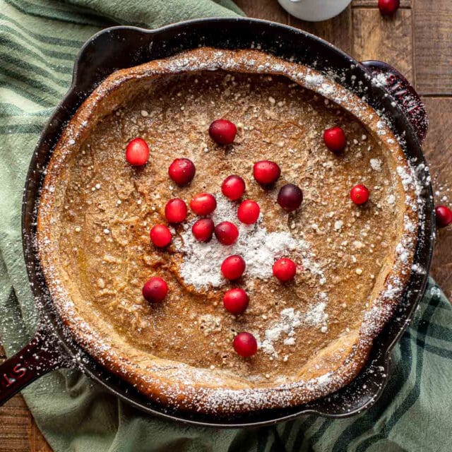 Gingerbread Dutch Baby Pancake in skillet with cranberries 1x1