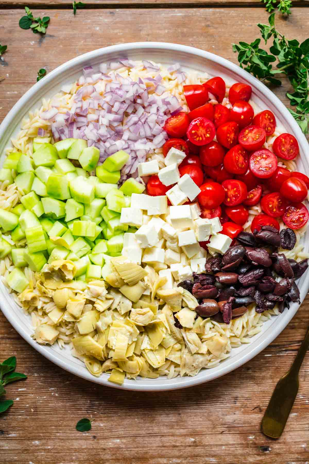 Greek Orzo Salad ingredients on serving platter