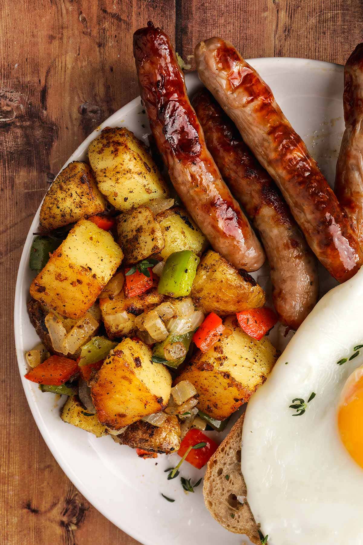 Home Fried Potatoes on serving plate with egg and sausage