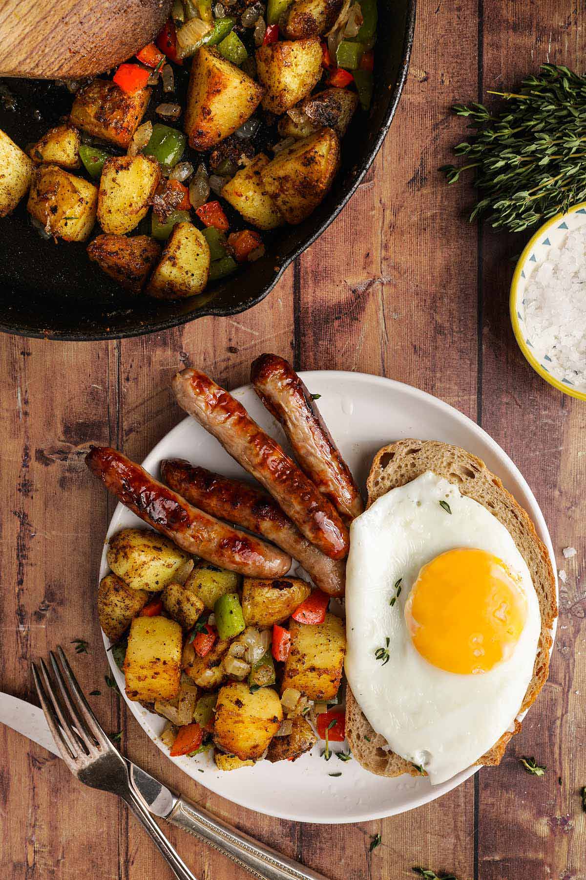 Home Fried Potatoes on serving plate with egg and sausage