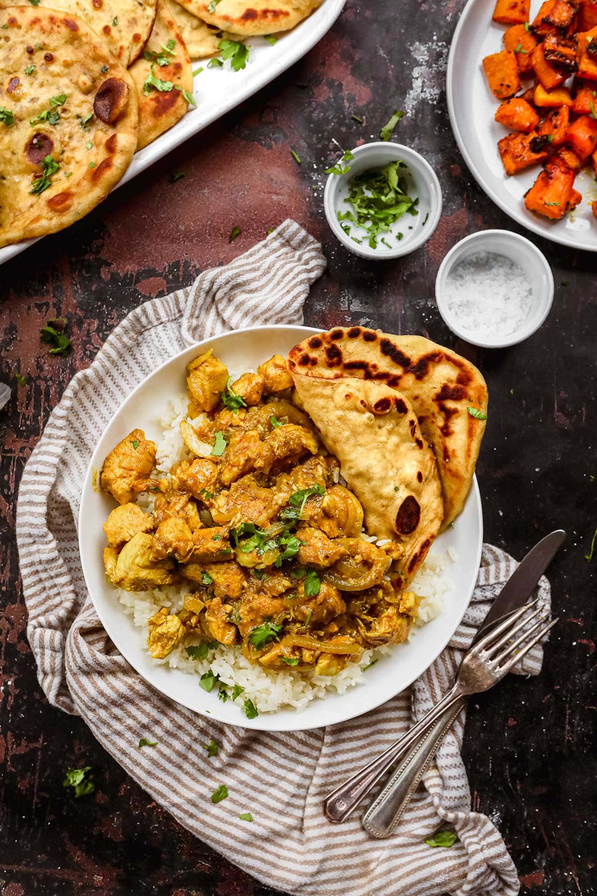 Indian Chicken Vindaloo on serving plate with rice and naan