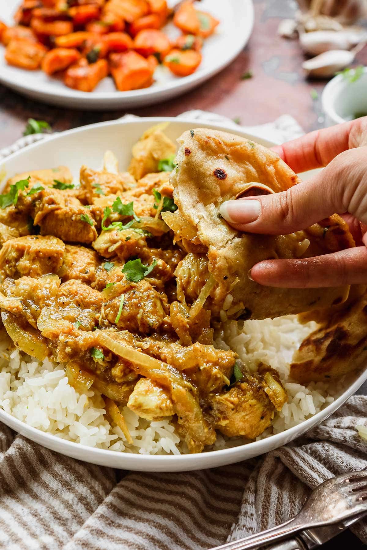 Indian Chicken Vindaloo and naan in hand