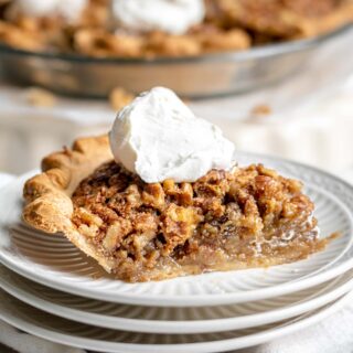 Maple Walnut Pie slice on serving plate with whipped cream 1x1