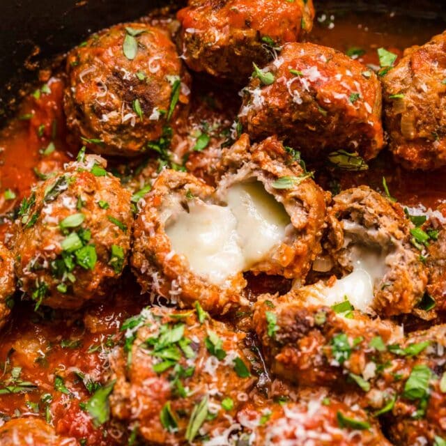 Mozzarella Stuffed Meatballs in sauce in skillet, showing melty cheese 1x1