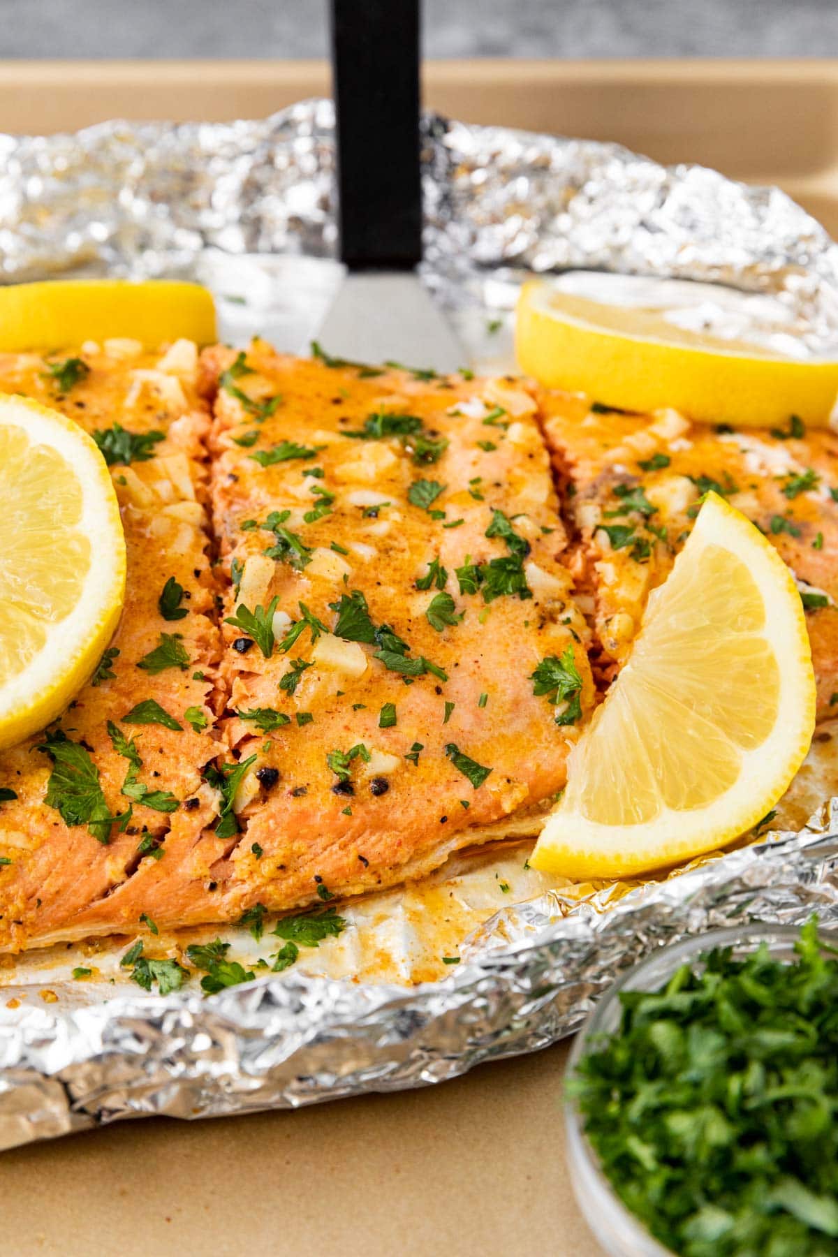 Oven Baked Salmon sliced on baking sheet with garnish