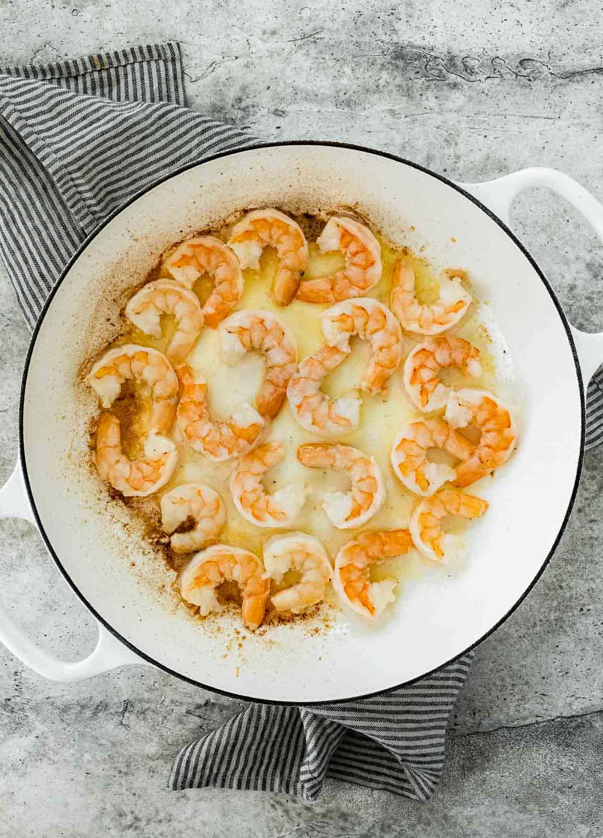 cooked shrimp in butter in a pan