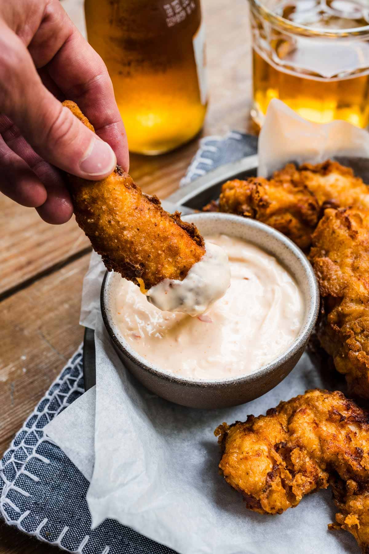 Texas Roadhouse Chicken Critters on serving plate dipping in Cajun Horseradish sauce