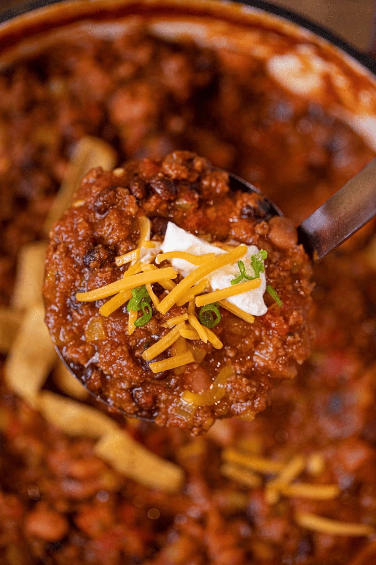Ladle of chili over the pot