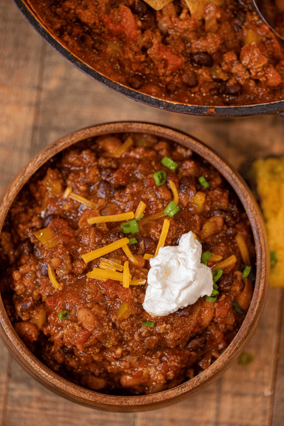Chili served in a wooden bowl with garnish